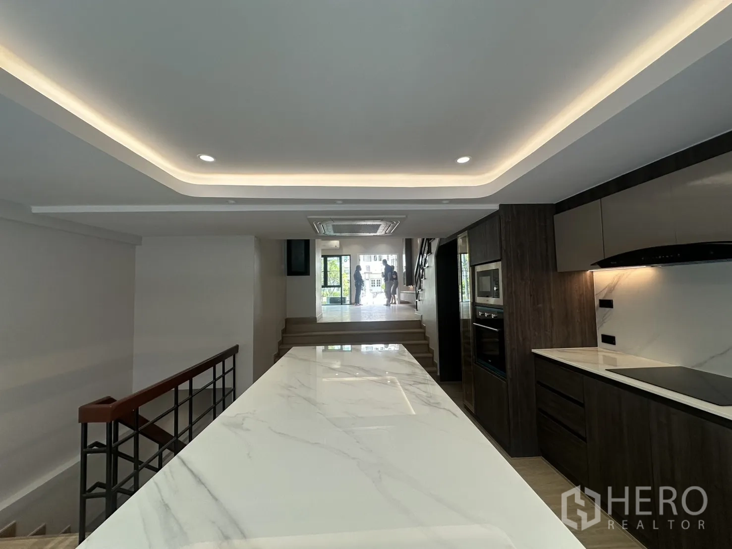 家庭办公室 for rent in Watthana, Bangkok - 俯视长形大理石岛台，前方为分层起居区与楼梯。