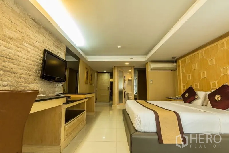 Retail Space for rent - Bedroom-style space with a TV wall, stone accent and fitted work desk.