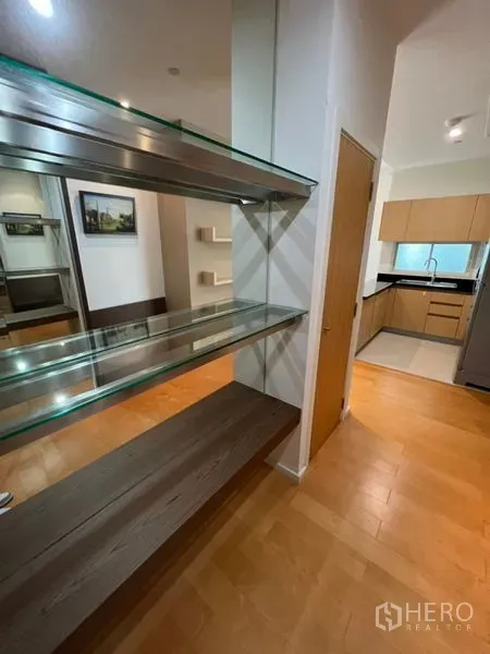 Condominium for rent in Chatuchak, Bangkok - Glass display shelves and wooden flooring beside the fitted kitchen