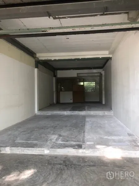 Retail Space for rent in Watthana, Bangkok - Deep shop space with split levels, white walls and a rear service area.