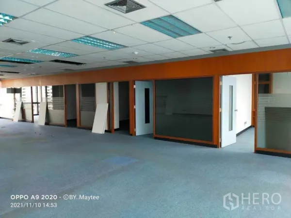 Office Space for rent in Watthana, Bangkok - Wide view of the open office showing multiple glass-fronted rooms and ample natural light.