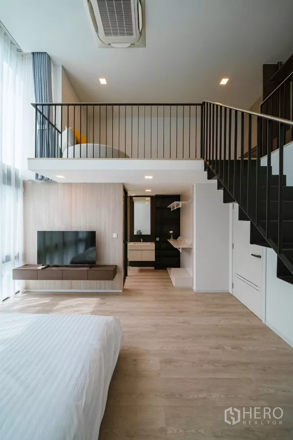 Detached House for rent or sale in Saphan Sung, Bangkok - Loft bedroom with mezzanine, TV wall, staircase and ensuite area.