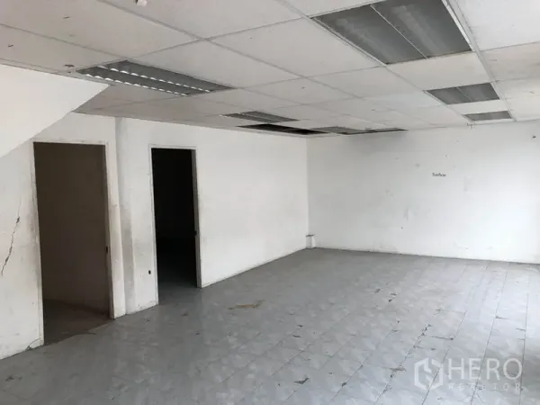 Warehouse for rent in Suan Luang, Bangkok - Tiled office room inside the warehouse with drop ceiling and separate doorways.