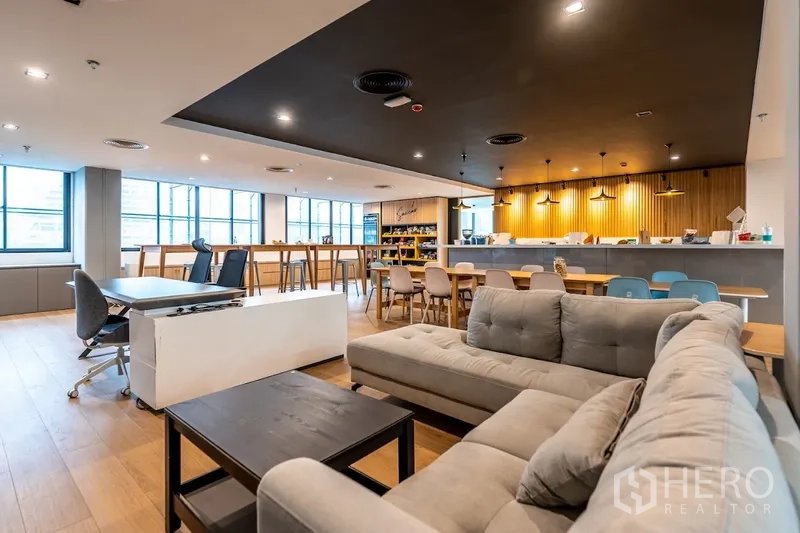 Office Space for rent in Bang Rak, Bangkok - Lounge and pantry area with sofa seating, high tables, and a long bar counter.
