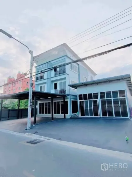 Home Office for rent in Bang Phli, Samut Prakan - Angled exterior of two combined units with wide driveway and multiple balconies.