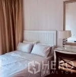 Condominium for rent in Watthana, Bangkok - Second bedroom with white headboard, desk, lamp and soft neutral decor.