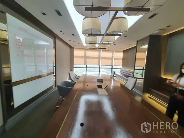 Office Space for rent in Watthana, Bangkok - Executive boardroom with a long table, pendant lights and wide windows.