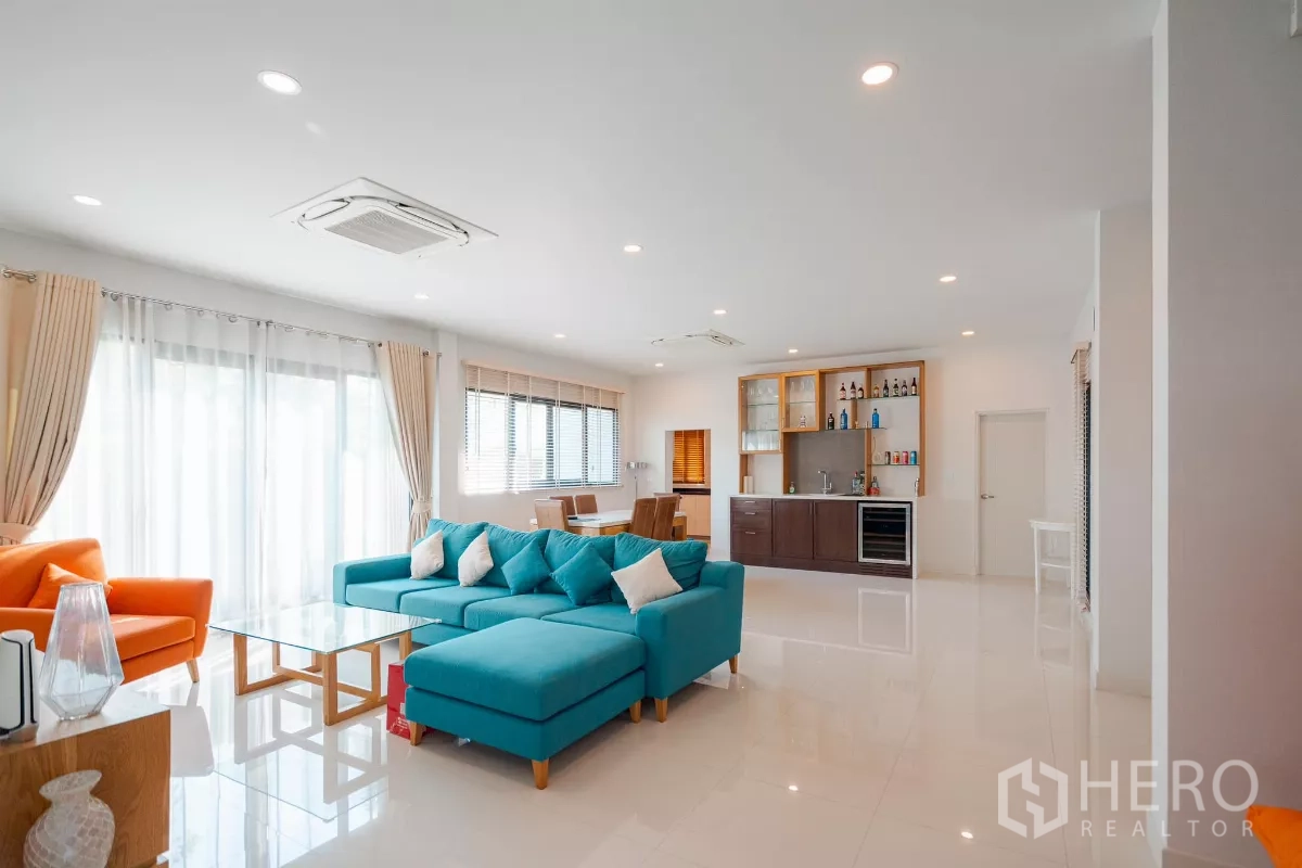 Detached House for sale in Saphan Sung, Bangkok - Expansive open plan with lounge, sliding glass doors and built-in bar cabinet.