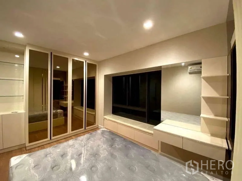 Detached House for rent - Second master bedroom with upholstered headboard, blue panel walls and large window.
