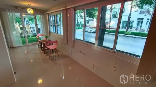 Detached House for rent in Bang Phli, Samut Prakan - Sunroom with large windows and a small table facing the front garden and gate.