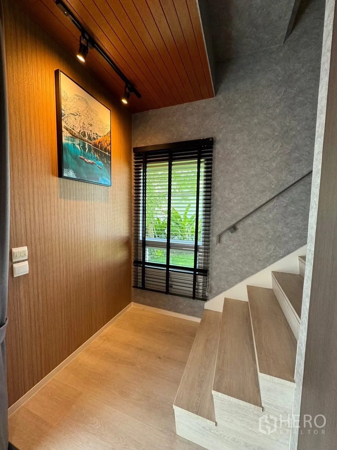 Detached House for rent in Prawet, Bangkok - Dining room view toward stairs and bar with pendant lighting.