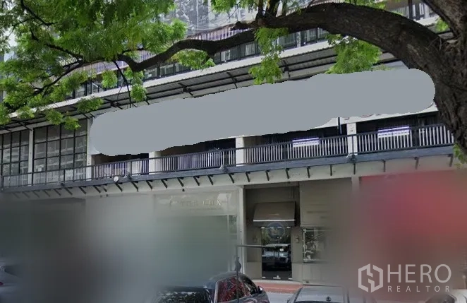 พื้นที่ขายปลีก ให้เช่าในKhlong Toei, Bangkok - ด้านหน้าพื้นที่ค้าปลีกติดถนนในคลองเตย กรุงเทพฯ กระจกบานใหญ่ ทางเดินมีหลังคา และร่มไม้