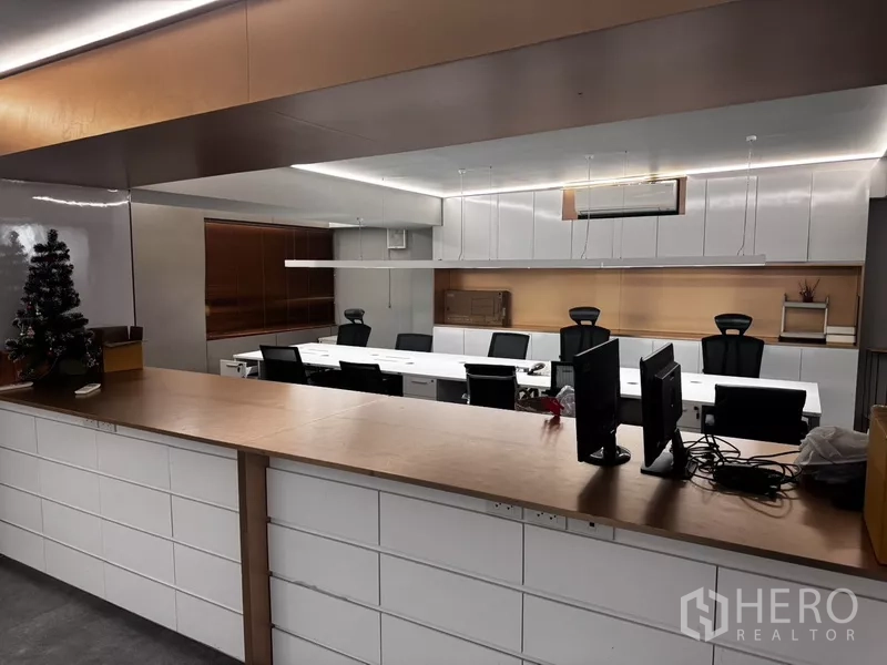 Office Space for rent or sale in Suan Luang, Bangkok - Built-in counter facing an open-plan office with desks, storage and ceiling lighting.