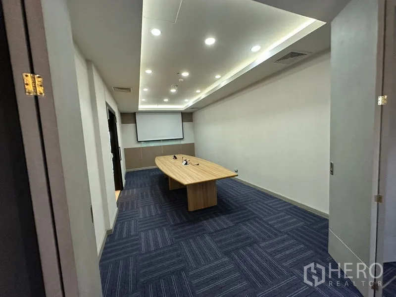 สำนักงาน ให้เช่า - ห้องประชุม โต๊ะยาว จอโปรเจคเตอร์ และไฟฝ้าเพดาน พื้นพรมสีน้ำเงิน