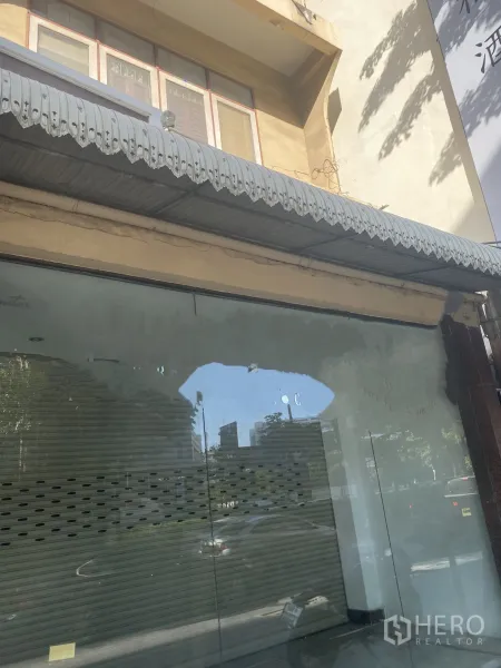Retail Space for rent in Watthana, Bangkok - Street-level retail shopfront with full-height glass facade, metal awning and internal shutter along Sukhumvit.