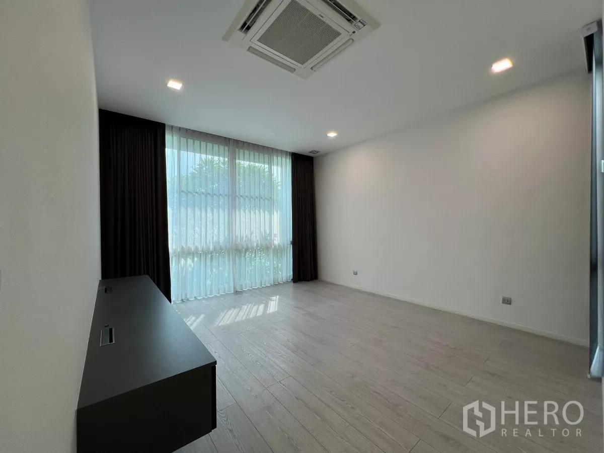 Detached House for sale in Bang Phli, Samut Prakan - Bright bedroom with large windows, sheer curtains and wood floors
