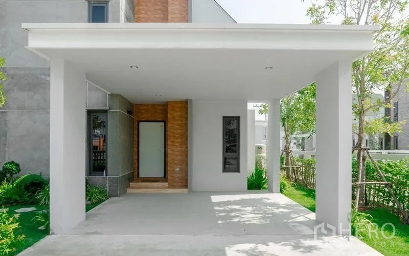Detached House for sale in Lam Luk Ka, Pathum Thani - Covered two-car parking area beside the front door.