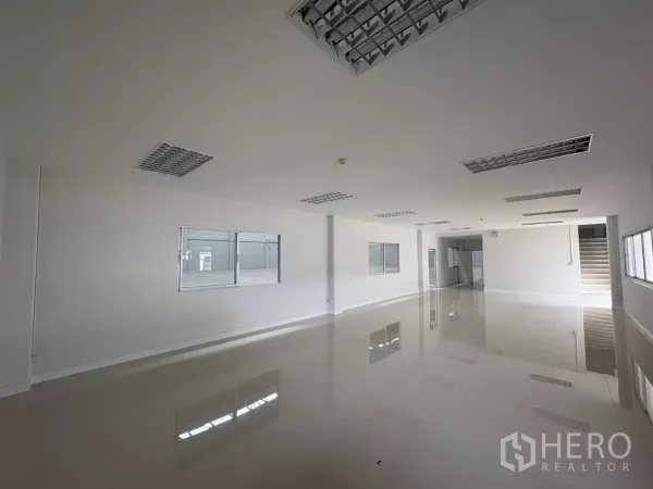 Factory for rent in Bang Phli, Samut Prakan - Bright ground-floor office space with glossy tile floors and multiple windows.
