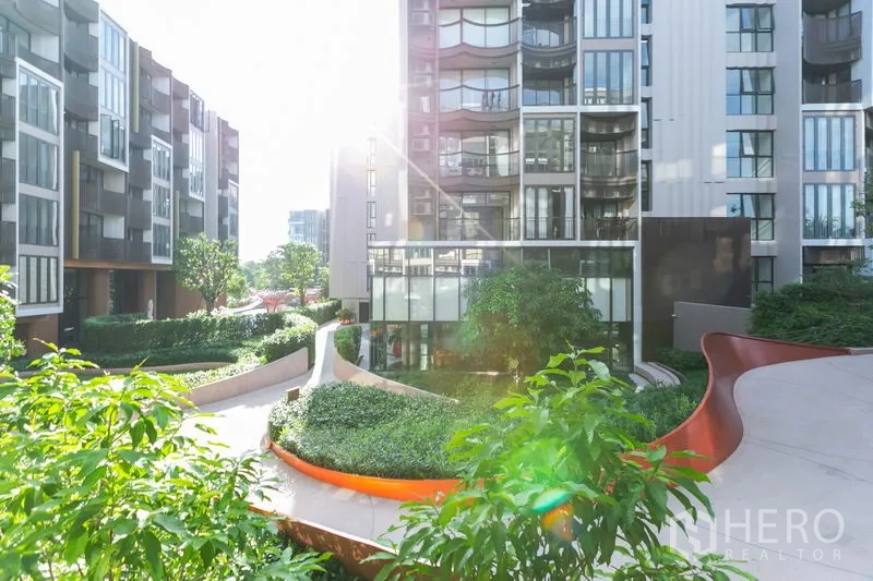 Condominium for rent in Watthana, Bangkok - Low-rise condominium buildings with landscaped garden paths and lush greenery.