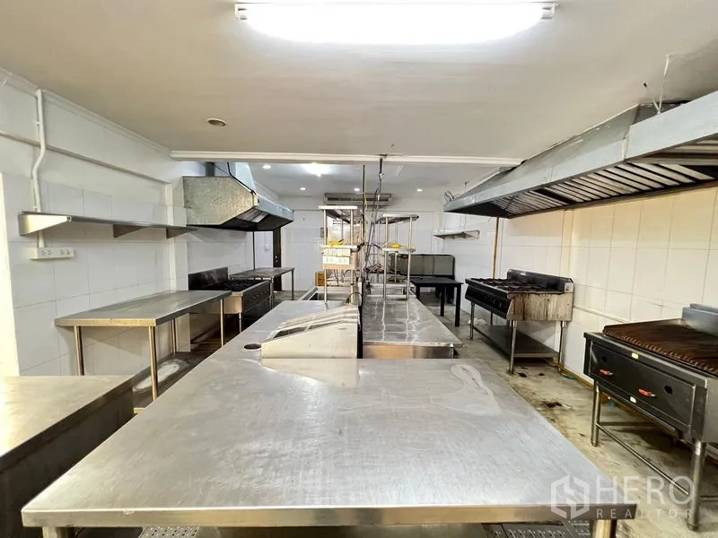 Retail Space for rent in Bangkok - Commercial kitchen with stainless worktops, ventilation hoods and grills.