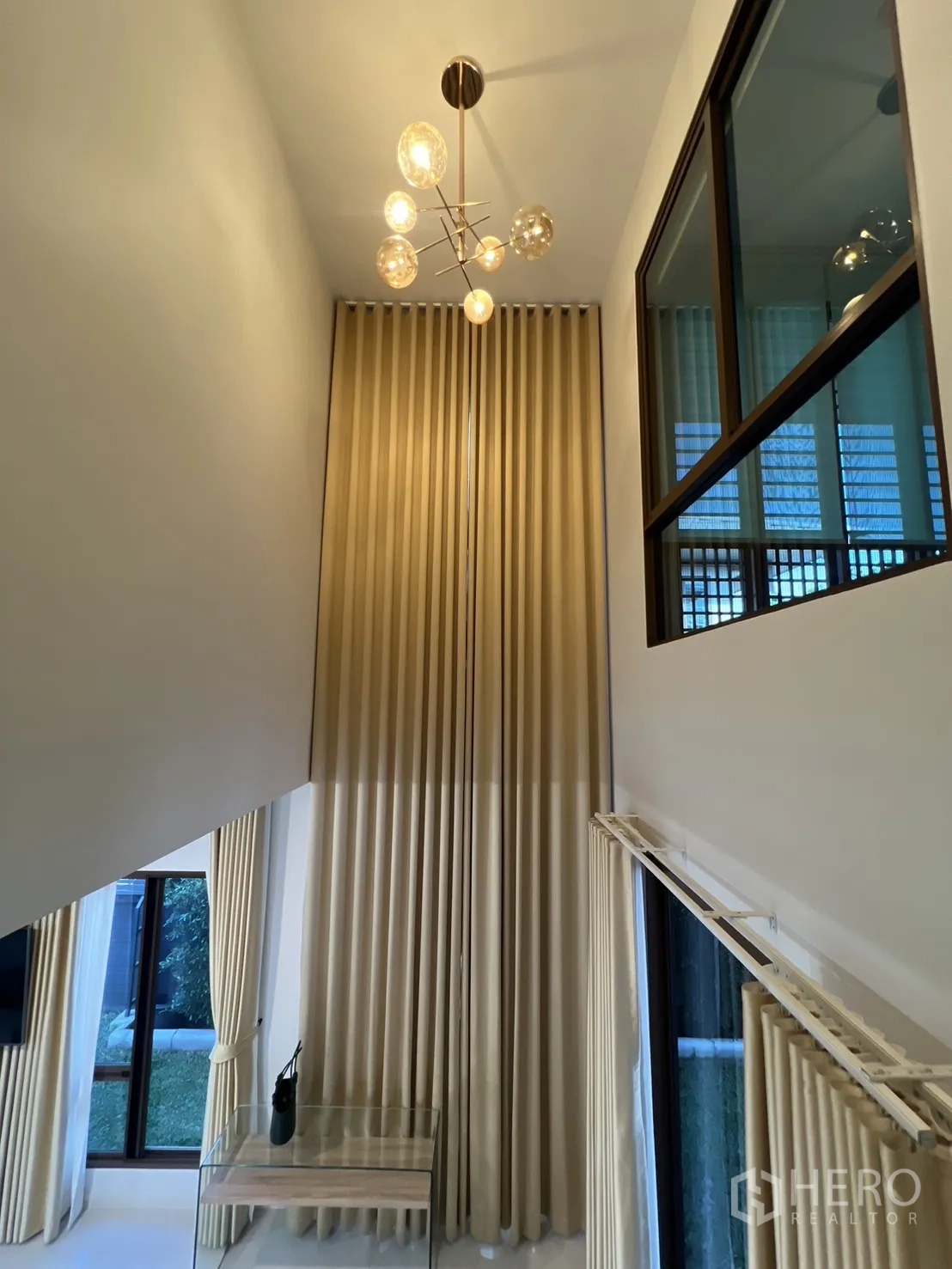 Detached House for rent or sale in Bang Kapi, Bangkok - Double-volume foyer with designer chandelier and tall curtains