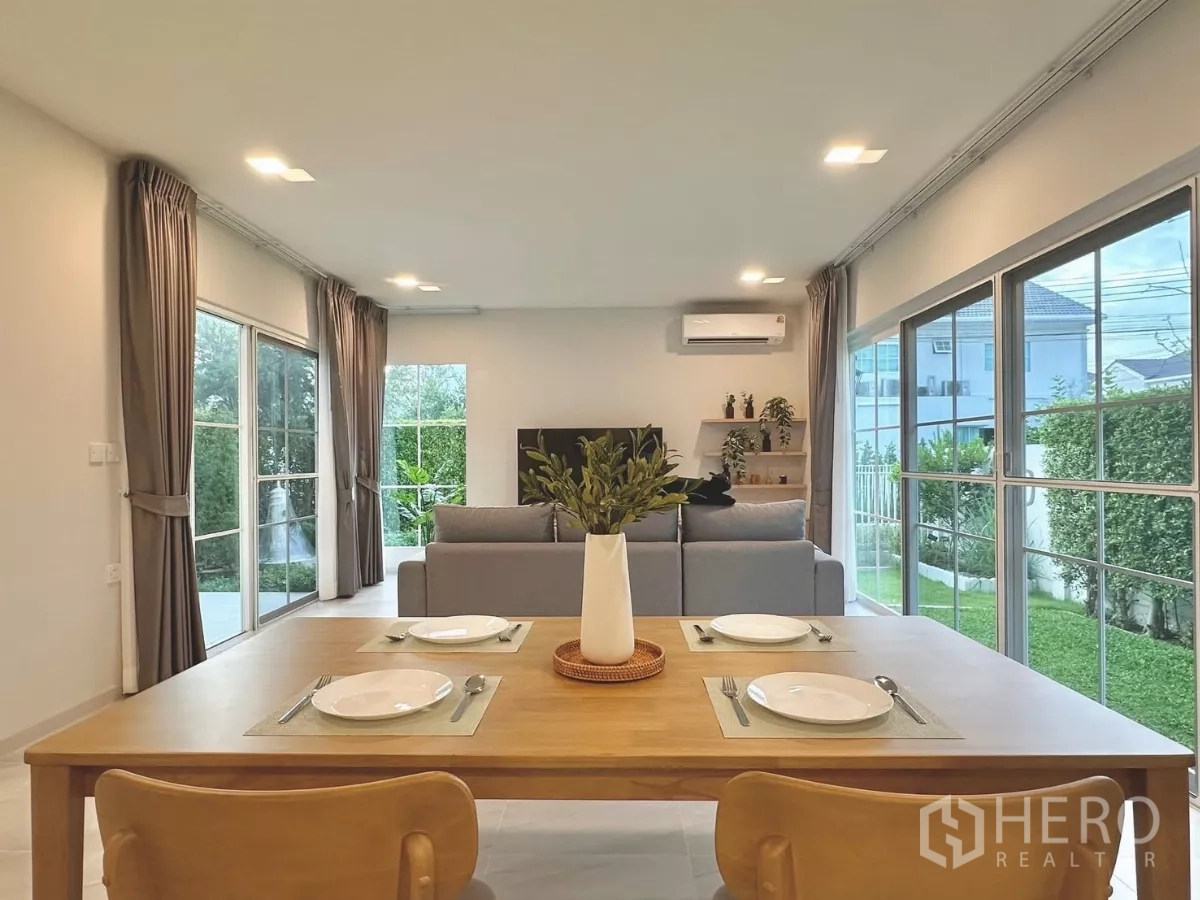 Detached House for rent in Bang Phli, Samut Prakan - Bright open-plan dining and living room with large sliding glass doors to the garden.