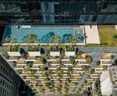 Condominium for rent - Aerial view of the condominium facade featuring a rooftop swimming pool and sky garden.