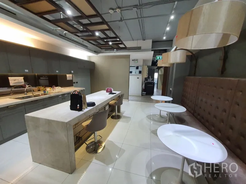 Office Space for rent in Khlong Toei, Bangkok - Pantry and break area with long island, built-in cabinets and banquette seating.