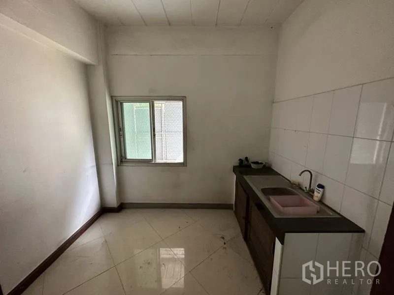 Factory for rent or sale in Bang Bua Thong, Nonthaburi - Compact pantry with tiled walls, countertop sink and small window.