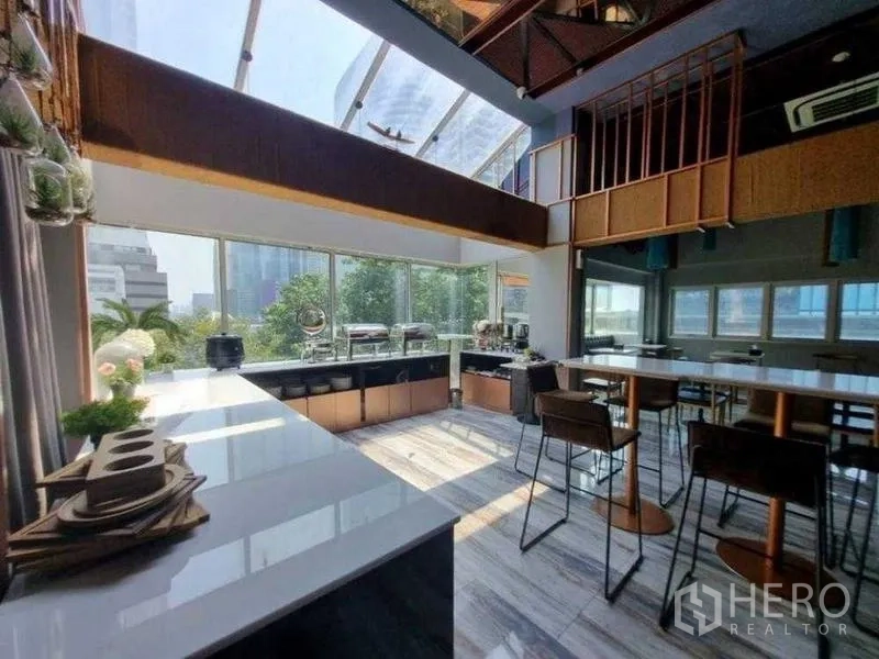 Retail Space for rent in Bang Rak, Bangkok - Sunlit cafe-style space with island counters and floor-to-ceiling windows.