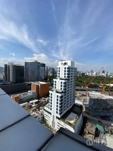 Condominium for rent in Bang Rak, Bangkok - High-floor city view over the Silom skyline with towers and blue sky.