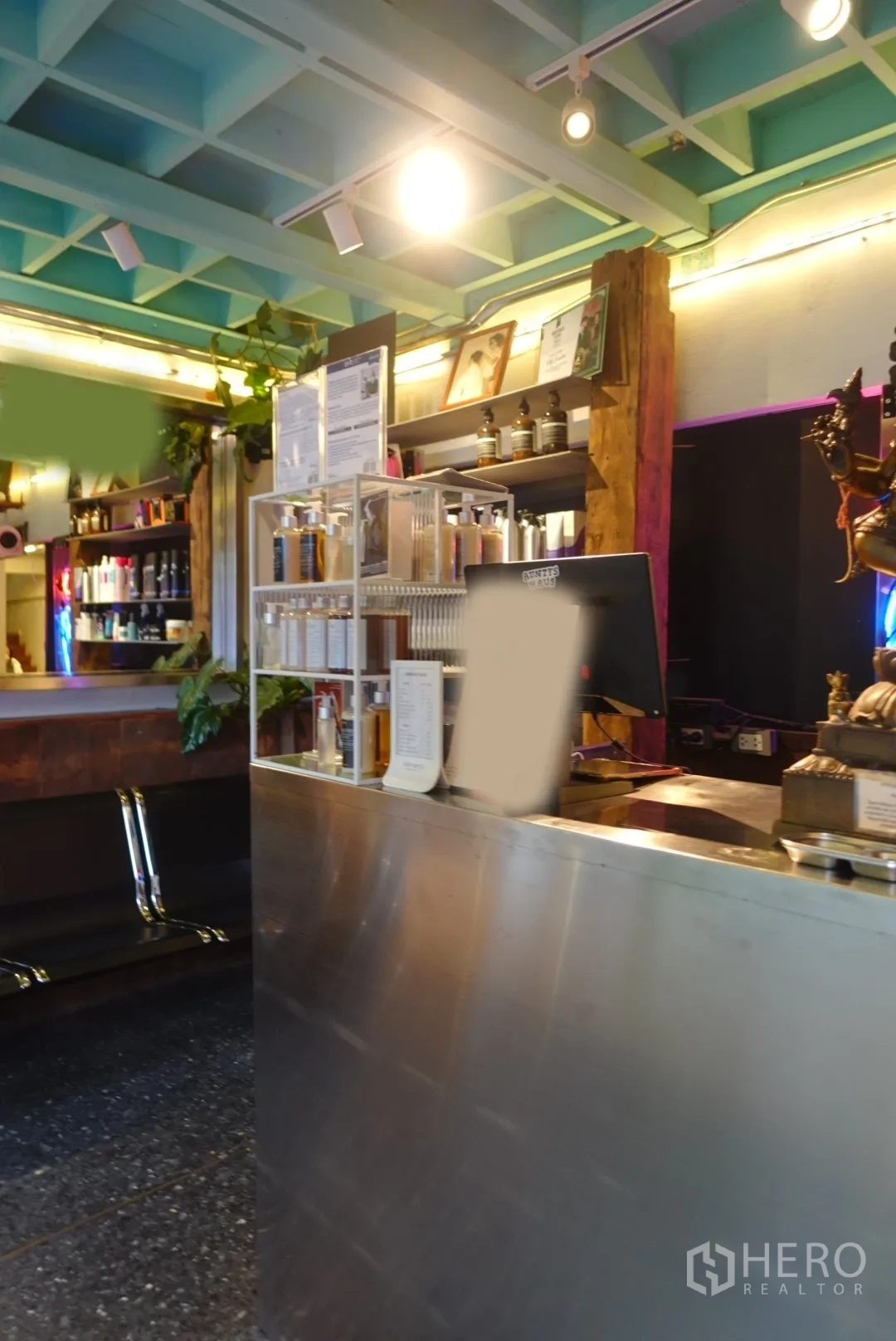 Retail Space for rent in Khlong Toei, Bangkok - Reception counter with product display shelves and track lighting inside the retail space.