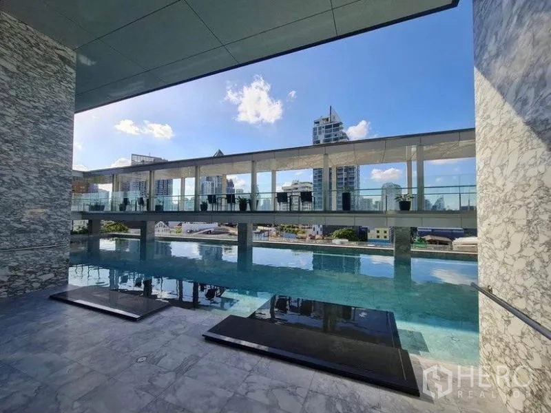 Condominium for rent in Khlong Toei, Bangkok - Outdoor elevated swimming pool with skyline backdrop and sun terrace.