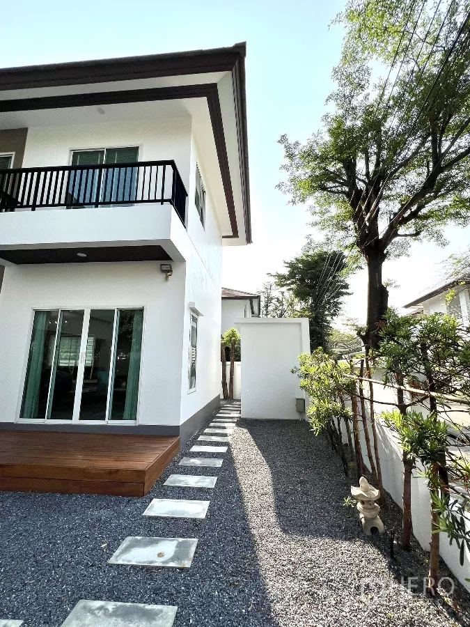 独立式住宅 出租或出售在Saphan Sung, Bangkok - 房屋侧院铺碎石与踏步道，旁有私密围墙。