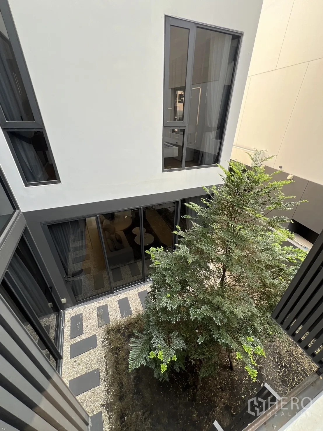 Detached House for rent in Suan Luang, Bangkok - Internal courtyard view with planted tree and stepping‑stone path.
