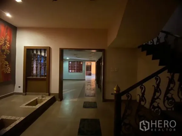 Retail Space for rent in Watthana, Bangkok - Entrance hall with artwork, recessed lighting, and a decorative iron staircase.