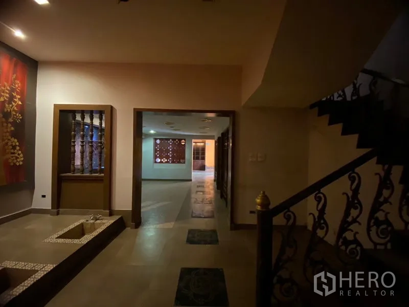 Retail Space for rent in Watthana, Bangkok - Entrance hall with artwork, recessed lighting, and a decorative iron staircase.