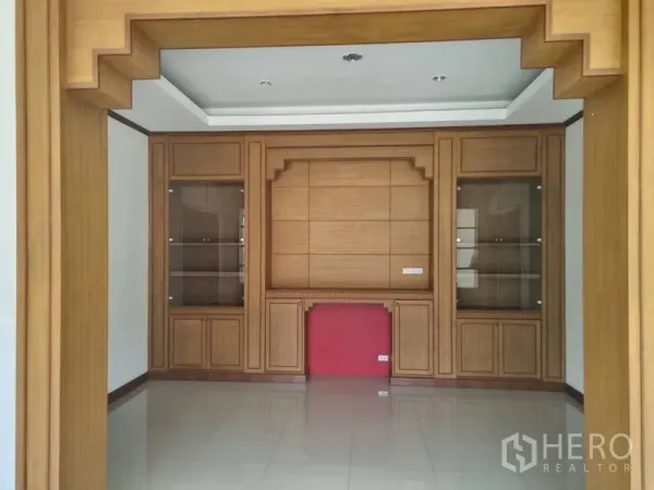 Warehouse for rent or sale in Krathum Baen, Samut Sakhon - Built-in wooden cabinetry feature wall in office or meeting room with glass display units.