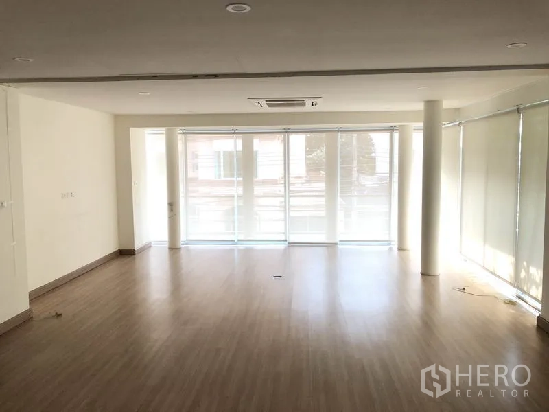 带办公室的家 出租在Wang Thonglang, Bangkok - 整层采光充足的办公区，落地窗、百叶帘与木地板。