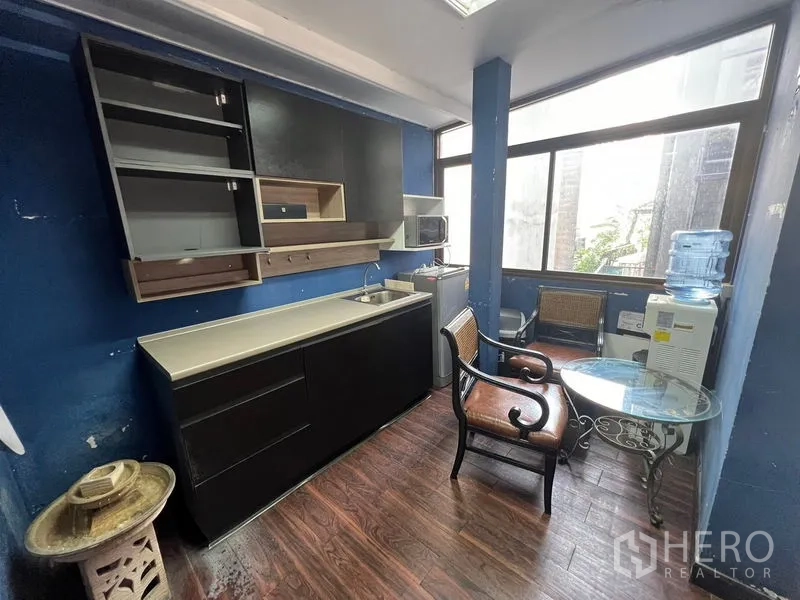 Retail Space for rent or sale in Khlong Toei, Bangkok - Pantry with kitchenette, seating and large windows providing natural light.