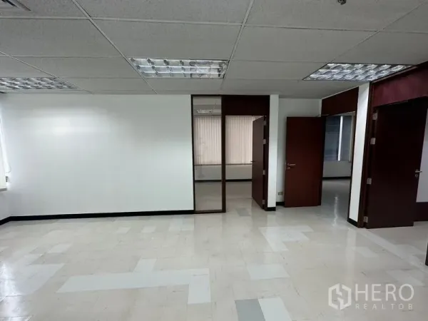 Office Space for rent in Chatuchak, Bangkok - Central office zone featuring a glass partition and several wooden doors.