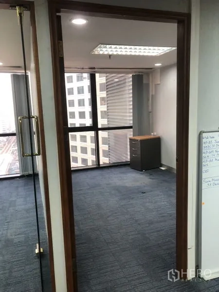 Office Space for rent - Glass-door entry to a private office with carpet flooring and skyline view.