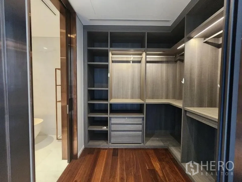 Condominium for sale - Walk-in closet with custom shelving and drawers adjacent to the master bathroom.