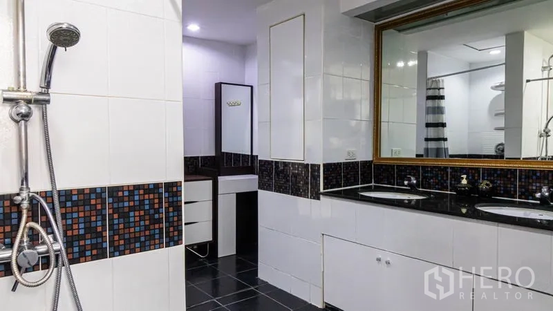 Condominium for rent or sale in Khlong Toei, Bangkok - Bathroom with double vanity, mosaic tile accents and glass shower.