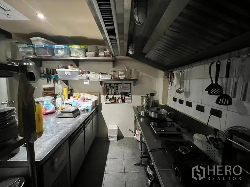 Retail Space for rent in Bang Rak, Bangkok - Second view of the commercial kitchen with gas hobs and wall-mounted utensils.