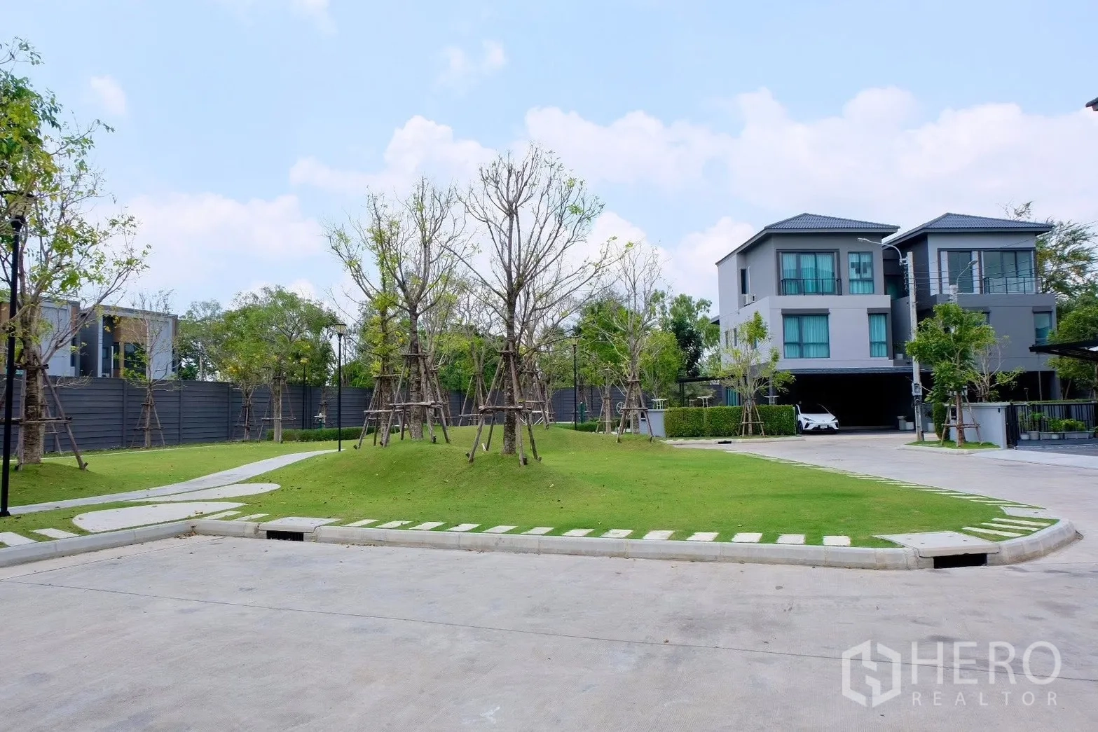 半独立式住宅 for sale in Prawet, Bangkok - 社区绿地，起伏草坪、幼树与人行小径。