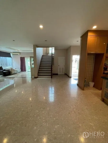 Detached House for rent - Spacious open-plan ground floor with glossy tile flooring, central staircase, and natural light.