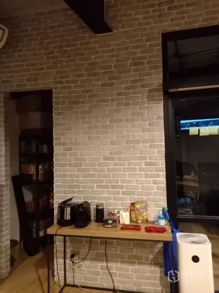 Office Space for rent in Chatuchak, Bangkok - Pantry corner with brick feature wall, countertop and small appliances.