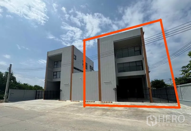 Factory for rent or sale in Bang Bua Thong, Nonthaburi - Modern three-storey factory facade with gated entrance, right-hand unit outlined.
