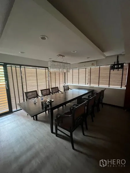 Retail Space for rent or sale in Khlong Toei, Bangkok - Private meeting or dining room with chandelier and long table beside window blinds.
